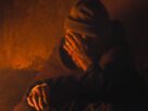 A senior monk in contemplation, enveloped in warm light, creating a serene atmosphere.
